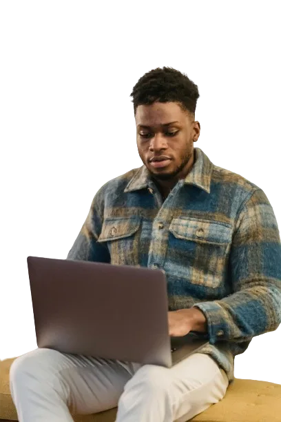 a man sitting with his laptop